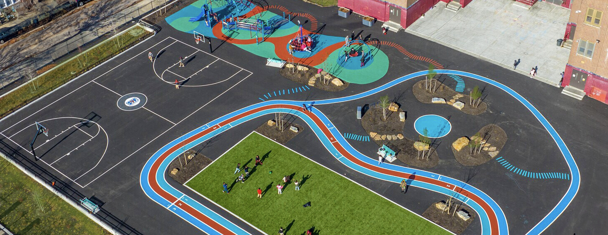 Bregy Elementary Schoolyard with Track, Courts, and Playground Aerial view of F. Amedee Bregy Elementary School's vibrant schoolyard